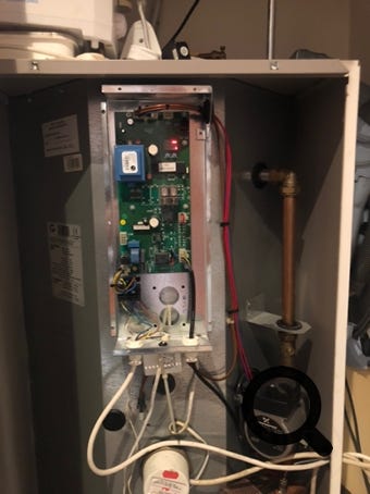 Inside a Pulsacoil Stainless, showing the circuit board, pump, top heater element etc